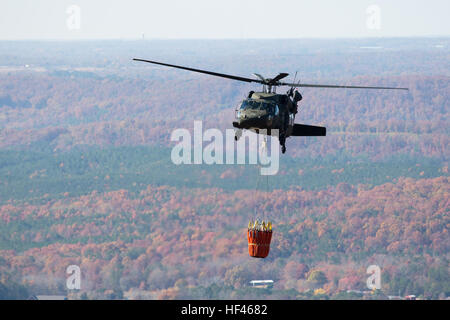 An Alabama National Guard UH-60 Black Hawk helicopter with Bambi bucket assembly provides aerial water delivery, at the request of the Alabama Emergency Management Agency, in support of forest fire suppression efforts in DeKalb County, Alabama, Nov.19, 2016. (Photo by Army Sgt William Frye.) 161119-A-OK577-548 (31138782586) Stock Photo