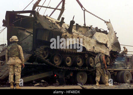 US Marine Corps (USMC) Marines assigned to Combat Services Support Battalion 18 (CSSB-18) work to retrieve a destroyed USMC Amphibious Assault Vehicle, (AAV7A1), during Operation IRAQI FREEDOM. AAV-Nsry Stock Photo