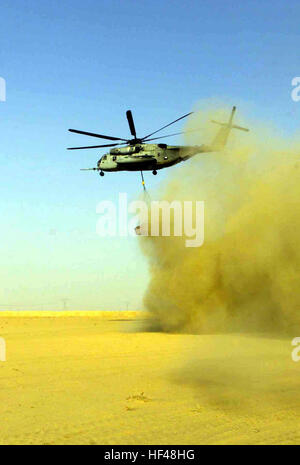 030401-M-6910K-136 Central Command Area of Responsibility (Apr. 1, 2003) -- CH-53 Super Stallion conducts external lift operations. The Helicopter Support Team (HST) provides loading and unloading of aircraft to include external lift operations for Logistic Support Area Viper, during Operation Iraqi Freedom. Operation Iraqi freedom is the multinational coalition effort to liberate the Iraqi people, eliminate Iraq's weapons of mass destruction, and end the regime of Saddam Hussein.  U.S. Marine Corps photo by Master Sgt. Edward D. Kniery.  (RELEASED) US Navy 030401-M-6910K-136 CH-53 Super Stall Stock Photo