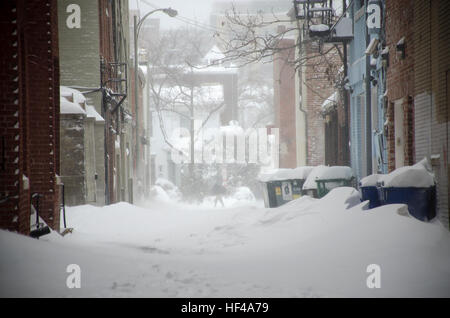 Gusts of wind blow clouds of snow in an alley in Washington DC. Stock Photo