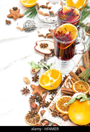 Mulled wine on white background. Hot red punch with fruit and spices. Christmas table decoration Stock Photo