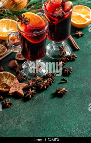 Mulled wine ingredients on dark background. Hot red punch with fruits and spices Stock Photo