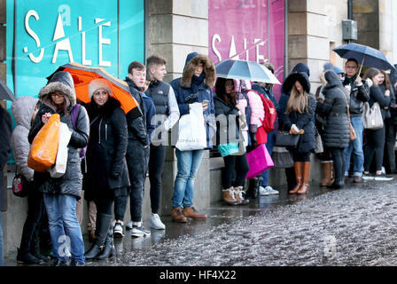 Shoppers queue outside the Harvey Nichols store in St Andrews Square, Edinburgh, for the Boxing Day sales. Stock Photo