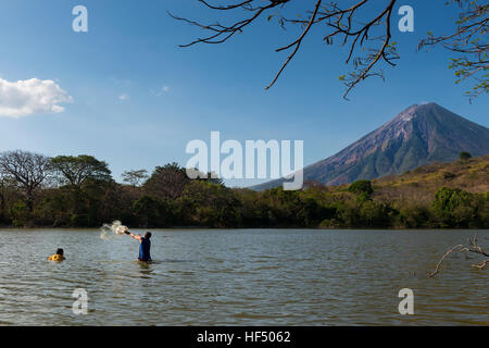 Ometepe Island, Nicaragua - April 7, 2014: Two fisherman fishing in the shores of the Ometepe Island in Lake Nicaragua. Stock Photo