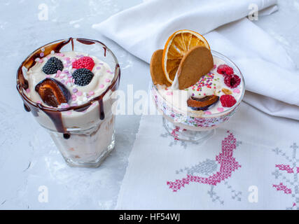 Delicate milk dessert with berries and biscuits in glasses on Valentine's Day. Stock Photo