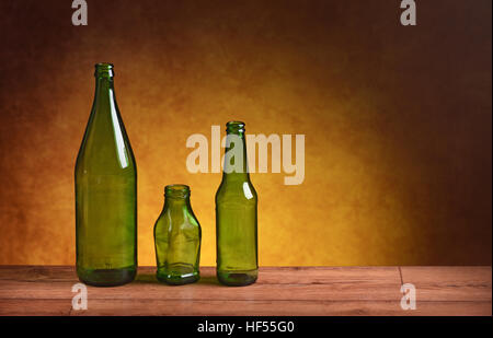green glass bottles on wood table Stock Photo