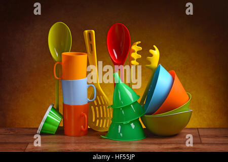 plastic kitchen utensils on wooden table Stock Photo