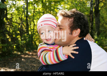 Father and his three-year-old daughter, hugging Stock Photo