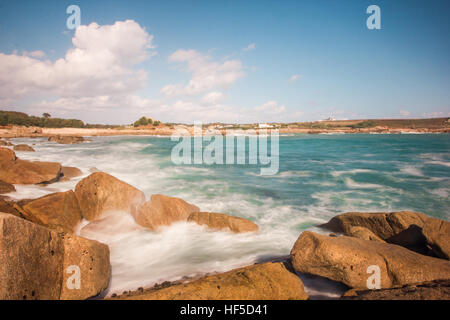 Waves break over the rocky shore on a sunny day, St Mary's, Isles of Scilly, October 2014 Stock Photo