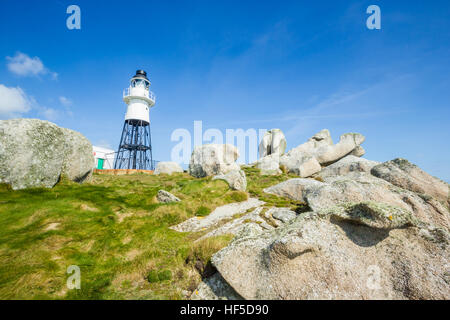 Penninis Lighthouse surrounded by rocks, Isles of Scilly, UK, March 2015 Stock Photo