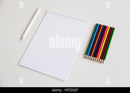 Blank sheet of paper and pencils on a white background. Branding Mock-Up. Stock Photo
