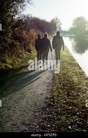 Walkers on the Grand Union Canal towpath in winter, Hatton Locks, Warwickshire, UK Stock Photo