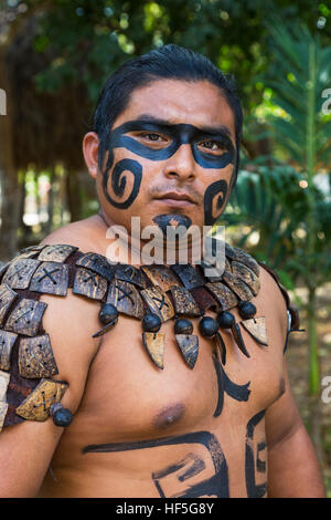 Local Mayan male dressed in the traditional face paint and body decorations of a Mayan warrior, Yucatan, Mexico Stock Photo