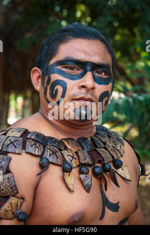 Local Mayan male dressed in the traditional face paint and body decorations of a Mayan warrior, Yucatan, Mexico Stock Photo