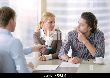 Young serious couple with agent Stock Photo