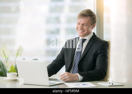 Smiling handsome businessman with laptop Stock Photo