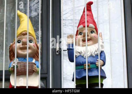 Gnomes on flat balcony appear to be in prison, Bermondsey, London Stock Photo