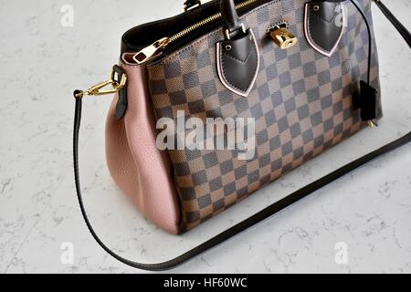 A Louis Vuitton handbag displayed on a white carrera marble background  Stock Photo - Alamy