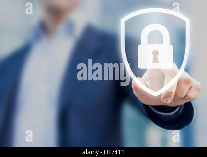 Person touching a shield with a lock symbol, concept about security, cybersecurity and protection against dangers Stock Photo