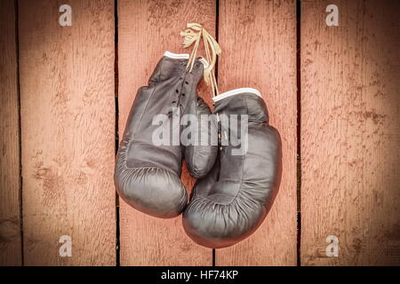 Old boxing gloves on wooden wall Stock Photo