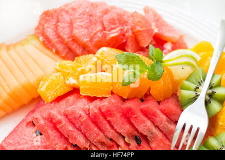 Dish with fresh sliced fruits. Composition on the plate Stock Photo