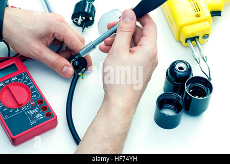 Man countersinking screw in a workshop using screwdriver Stock Photo