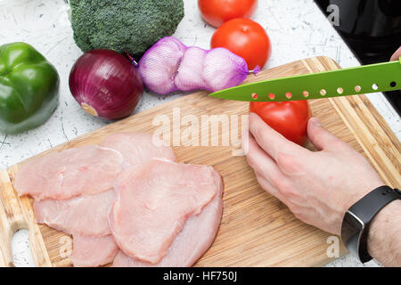Man cutting vegetables and prepares healthy dinner Stock Photo