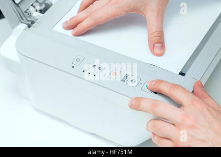 Man puts start button on scanner panel Stock Photo