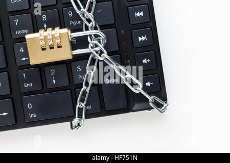 Locked chain on computer keyboard. Concept of security Stock Photo