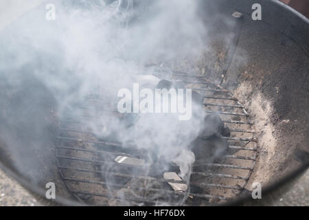 Smoke coming out of grill with briquette, closeup Stock Photo - Alamy