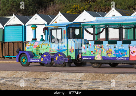 The home of Peppa Pig world - Landtrain on the promenade at Middle Chine, Bournemouth with beach huts on Boxing Day Stock Photo