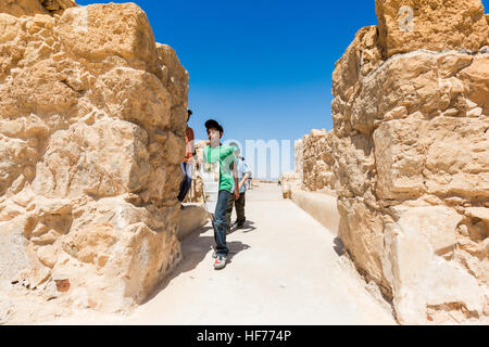 MASADA, ISRAEL - APRIL 7, 2016: children with a map explore ancient hills and ruins of Roman Fortress in Masada National Park , a World Heritage Site 