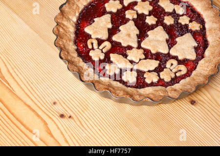 Decorated Linzer torte on wooden board Stock Photo