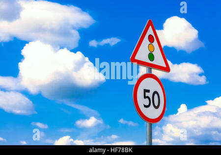 two road signs speed limit on a background of blue sky and clouds Stock Photo