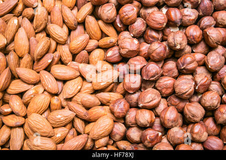 Peeled almonds and hazelnuts background or texture Stock Photo