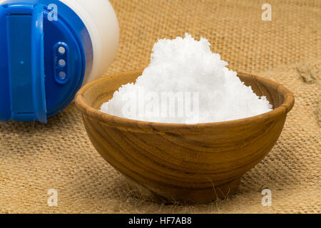 White salt in a wooden bowl on sackcloth Stock Photo