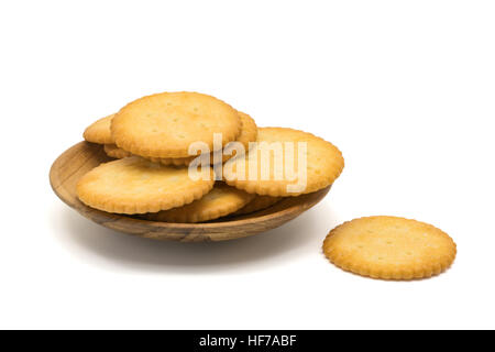 Salted round cracker in a wooden plate on white background Stock Photo