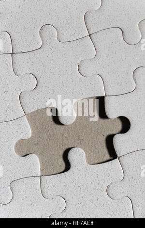 Blank white jigsaw puzzle and missing piece as copy space Stock Photo