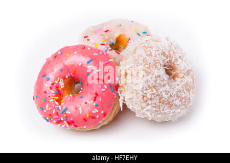 Three donuts isolated on White Background. Pink, Frosted and Coconut with sprinkles. Stock Photo