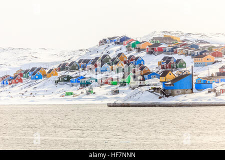 Colorful Inuit houses on the hill, at sea shore, Aasiaat city, North Greenland Stock Photo