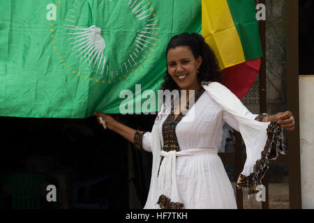 A woman holds the flags of African Union and Ethiopia during celebrations to mark the Ethiopian New Year in Baidoa, Somalia on September 11, 2016.  / Sabir Olad Stock Photo