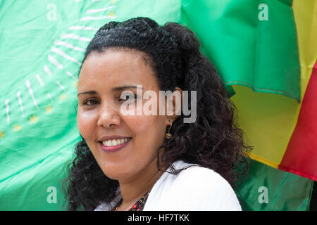 A woman holds the flags of African Union and Ethiopia during celebrations to mark the Ethiopian New Year in Baidoa, Somalia on September 11, 2016.  / Sabir Olad Stock Photo