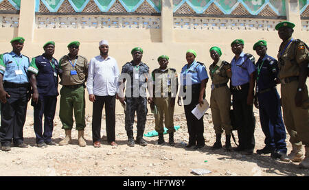 ACP Francis Ayitey Aryee, the African Union Mission in Somalia (AMISOM) Police Training and Development Coordinator, who is also a member of the Somali Election Security Task Force,  and Mohamed Abdinor Ahmed, the Jubbaland Task Force Officer in a group photo with AMISOM Individual Police Officers (IPOs), in Kismaayo, Somalia. The team visited to assess the security at polling centres on November 07, 2016. / Awil Abukar Stock Photo