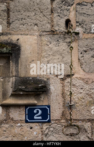 Door number on old stone wall in France Stock Photo