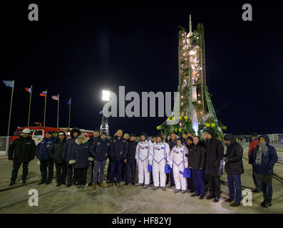 Expedition 50 crewmembers ESA astronaut Thomas Pesquet, left, Russian cosmonaut Oleg Novitskiy of Roscosmos, center, and NASA astronaut Peggy Whitson pose for a group photograph with mission managers in front of the Soyuz rocket at the launch pad, Thursday, Nov. 17, 2016, at the Baikonur Cosmodrome in Kazakhstan. Whitson, Novitskiy, and Pesquet will spend approximately six months on the orbital complex. Stock Photo