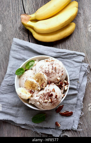 Dessert banana ice cream with nuts, country style, top view Stock Photo