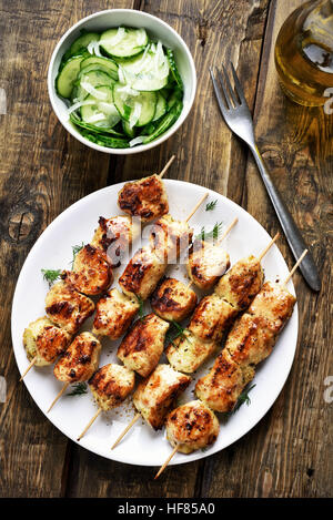Chicken kebab and salad from cucumber, country style, top view Stock Photo