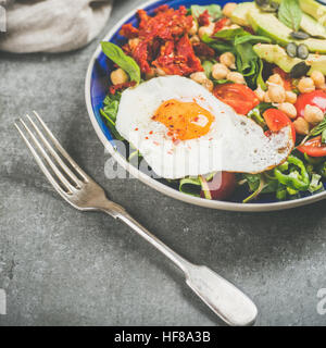 Dieting concept breakfast with fried egg, chickpea, vegetables, seeds Stock Photo