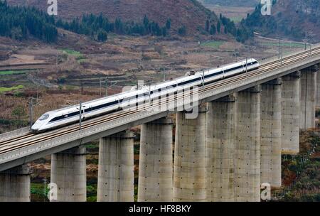 (161228) -- ANSHUN, Dec. 28, 2016 (Xinhua) -- The G4135 train runs on the Shuitongmuzhai bridge of the Shanghai-Kunming high-speed railway in Anshun, southwest China's Guizhou Province, Dec. 28, 2016. China on Wednesday put into operation one of the world's longest high-speed railways, linking the country's prosperous eastern coast to the less-developed southwest. The Shanghai-Kunming line -- 2,252 km in length -- traverses the five provinces of Zhejiang, Jiangxi, Hunan, Guizhou and Yunnan and cuts travel time from Shanghai to Kunming from 34 to 11 hours, according to China Railway Corporation Stock Photo