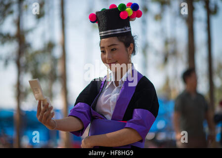 Luang Prabang, Laos. 29th Dec, 2016. The New Year Celebration starts on the morning of the first day of the new year and may last three or more days. Festivities of the New Year's celebration include ball tossing, song contests, Qeej performances and sporting activities, such as top playing, kicking, and bull fighting. Hmong girls are wearing their most elaborately embroidered new outfits. © Velar Grant/ZUMA Wire/Alamy Live News Stock Photo